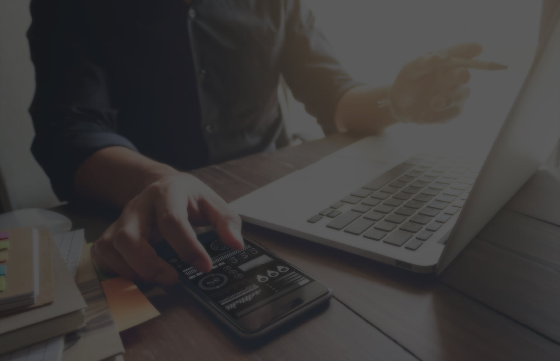 IT professional pointing to laptop